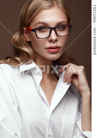 Beautiful girl in stylish clothes with glasses for vision and red sexy lips. Beautiful girl in stylish clothes with glasses for vision and red sexy lips. 49855261