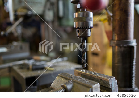 Drilling with a drilling machine Drilling with a drilling machine 49856520