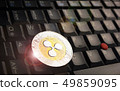 Ripple XRP  coin over a black laptop keyboard 49859095