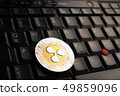 Ripple XRP  coin over a black laptop keyboard 49859096