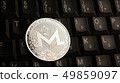 Silver Monero XMR coin on laptop keyboard 49859097