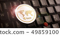 Golden ripple XRP coin over laptop keyboard 49859100