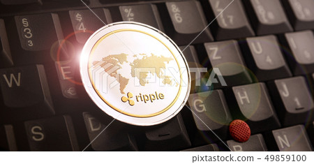 Golden ripple XRP coin over laptop keyboard 49859100