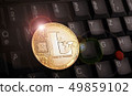 Golden litecoin LTC coin over laptop keyboard 49859102
