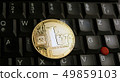 Golden Litecoin LTC  coin over  a black laptop  49859103