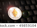 Golden Ethereum ETH coin over black keyboard 49859104
