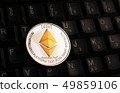 Golden Ethereum ETH coin over black keyboard 49859106