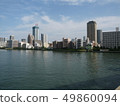 A group of buildings along the river 49860094