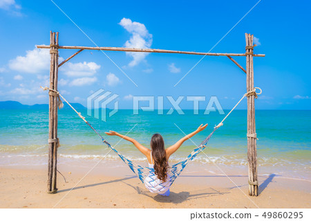 Portrait beautiful young asian woman happy smile leisure on the beach sea and ocean Portrait beautiful young asian woman happy smile leisure on the beach sea and ocean 49860295