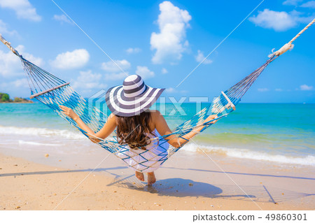 Portrait beautiful young asian woman happy smile leisure on the beach sea and ocean 49860301