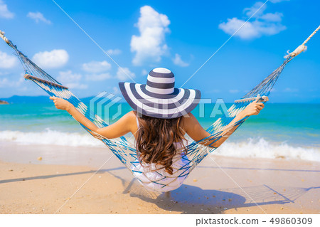 Portrait beautiful young asian woman happy smile leisure on the beach sea and ocean 49860309