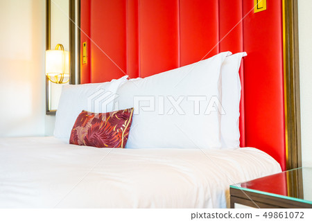 Comfotable pillow on bed with light lamp decoration Comfotable pillow on bed with light lamp decoration 49861072