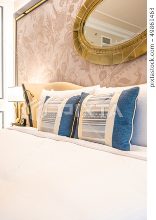 Comfotable pillow on bed with light lamp decoration Comfotable pillow on bed with light lamp decoration 49861463