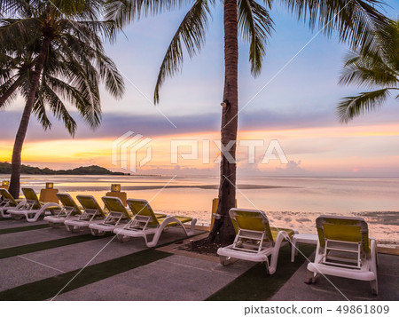 Beautiful tropical beach sea and ocean with coconut palm tree at sunrise time Beautiful tropical beach sea and ocean with coconut palm tree at sunrise time 49861809