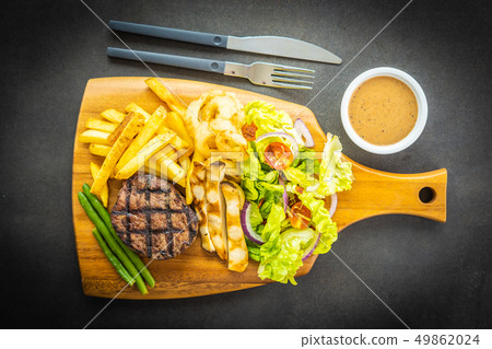 Grilled beef meat steak with french fries sauce and fresh vegetable 49862024