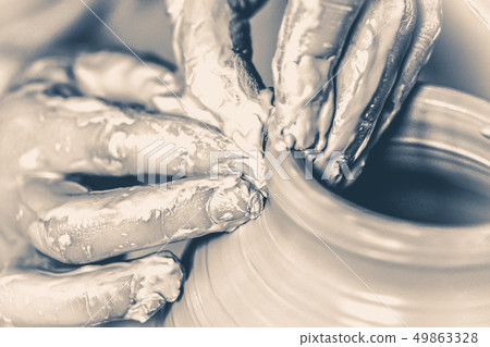 Photo in old vintage style. Hands in the clay macro Photo in old vintage style. Hands in the clay macro 49863328