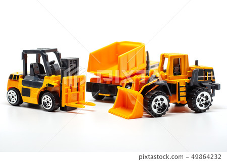 Yellow toy heavy machinery on white background Yellow toy heavy machinery on white background 49864232