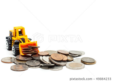 A yellow toy bulldozer with stack of coins A yellow toy bulldozer with stack of coins 49864233