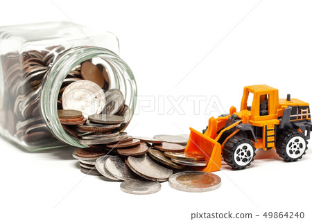 A yellow toy bulldozer with pile of coins 49864240