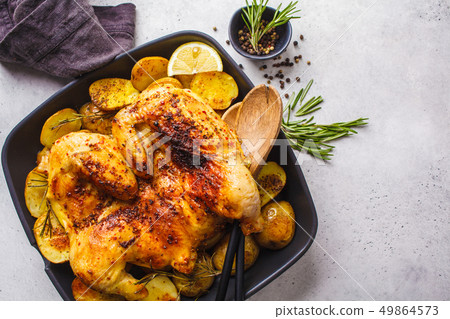 Fried whole tabaka chicken with potatoes 49864573