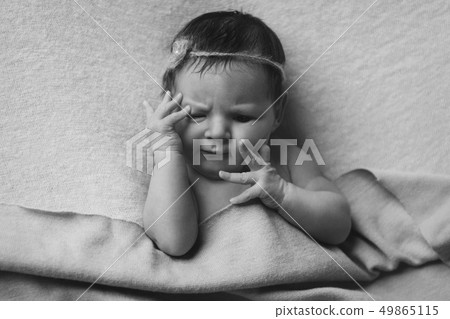 portrait of a newborn baby with a pen at the face portrait of a newborn baby with a pen at the face 49865115