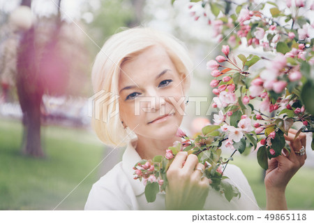 beautiful blonde with short hair among flowers 49865118