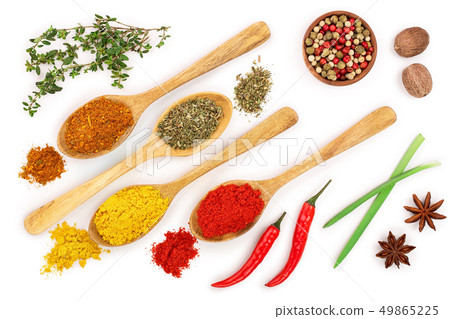 mix of spices in wooden spoon isolated on a white background. Top view. Flat lay. Set or collection 49865225