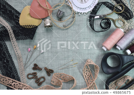 Sewing scene table flat lay composition. Threads, lace, pins, scissors, tape, reel, cloth. Pastel Sewing scene table flat lay composition. Threads, lace, pins, scissors, tape, reel, cloth. Pastel 49865675