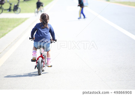 Child riding a bicycle 49866908