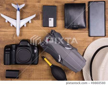 Flat lay top view of traveler accessories on white wooden background. 49868580