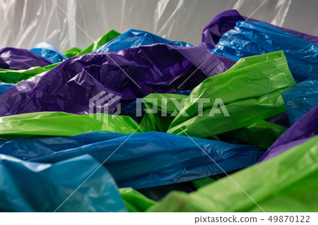 Colorful cheap plastic bags being intertwined together on camera 49870122