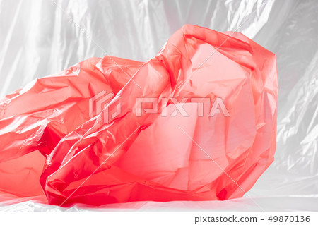 Transparent bright piece of cheap plastic lying on the floor 49870136