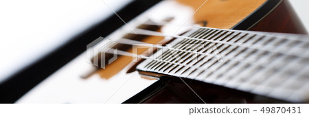 Small Hawaiian four stringed ukulele guitar 49870431