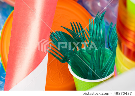 Toxic green plastic forks collected in a cup Toxic green plastic forks collected in a cup 49870487