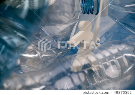 Abstract model of alive man stuck between plastic bottle thrown in a pile Abstract model of alive man stuck between plastic bottle thrown in a pile 49870592