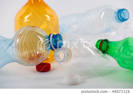 Clear water bottles lying together and being crumpled 49871128