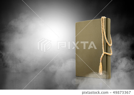 Quran and prayer beads on the table with smoke Quran and prayer beads on the table with smoke 49873367