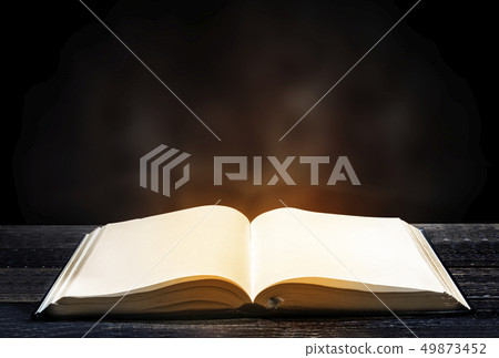 Quran open on wooden table Quran open on wooden table 49873452