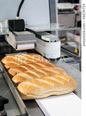 loaves of white bread cut into pieces in a bakery loaves of white bread cut into pieces in a bakery 49876754