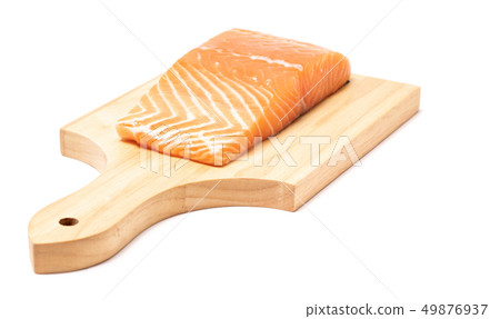 Salmon fish meat on wooden chopping block Salmon fish meat on wooden chopping block 49876937