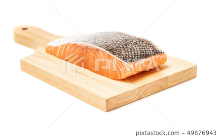 Salmon fish meat on wooden chopping block 49876943