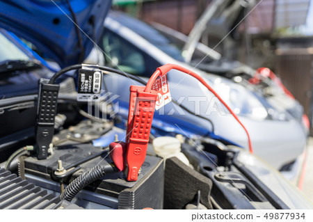 Car battery run-up and first aid Jumping start with booster cable Car battery run-up and first aid Jumping start with booster cable 49877934