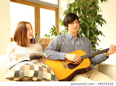 Image of a boyfriend and her girlfriend playing the guitar 49878108