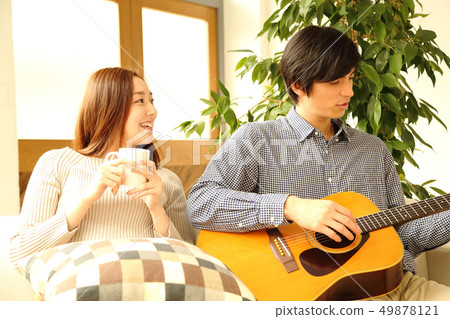 Image of a boyfriend and her girlfriend playing the guitar 49878121