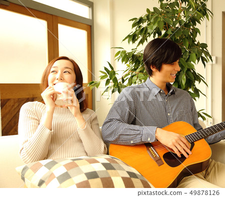 Image of a boyfriend and her girlfriend playing the guitar Image of a boyfriend and her girlfriend playing the guitar 49878126