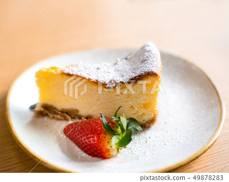 slice of cheesecake with strawberry on brown background, selective focus 49878283