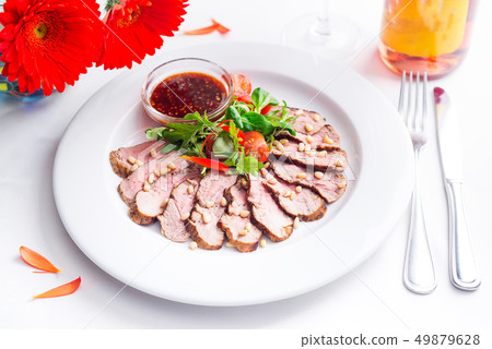 Tasty sliced roast duck breast with fresh vegetable salad and with cranberry sauce. Peking duck Tasty sliced roast duck breast with fresh vegetable salad and with cranberry sauce. Peking duck 49879628