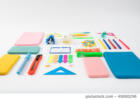 Bunch of colorful bright stationary and gadget cases lying on the white surface Bunch of colorful bright stationary and gadget cases lying on the white surface 49880296