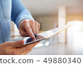 A man using tablet in a business center 49880340
