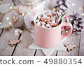 A pink mug full of cocoa with marshmallows 49880354
